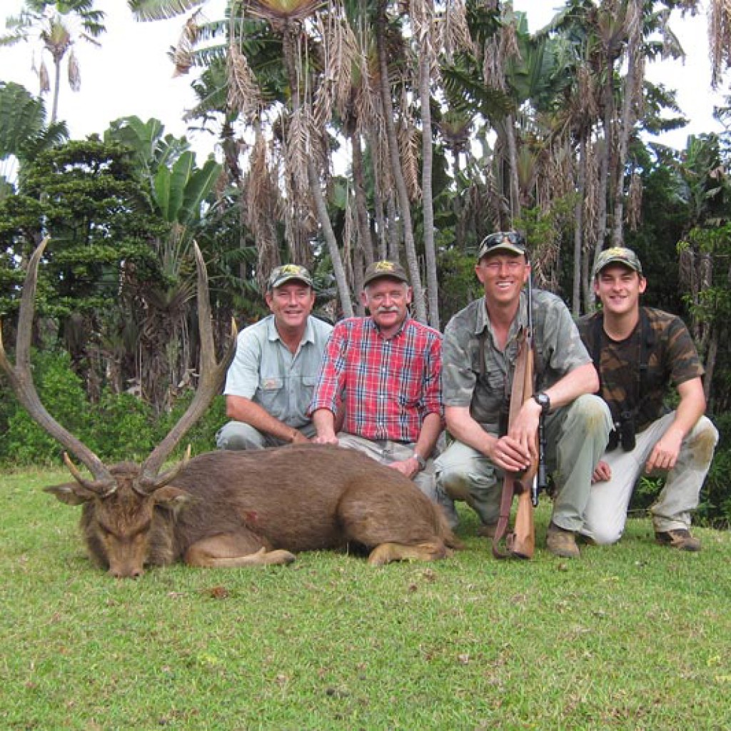 Hunter with Rusa deer trophy in natural setting